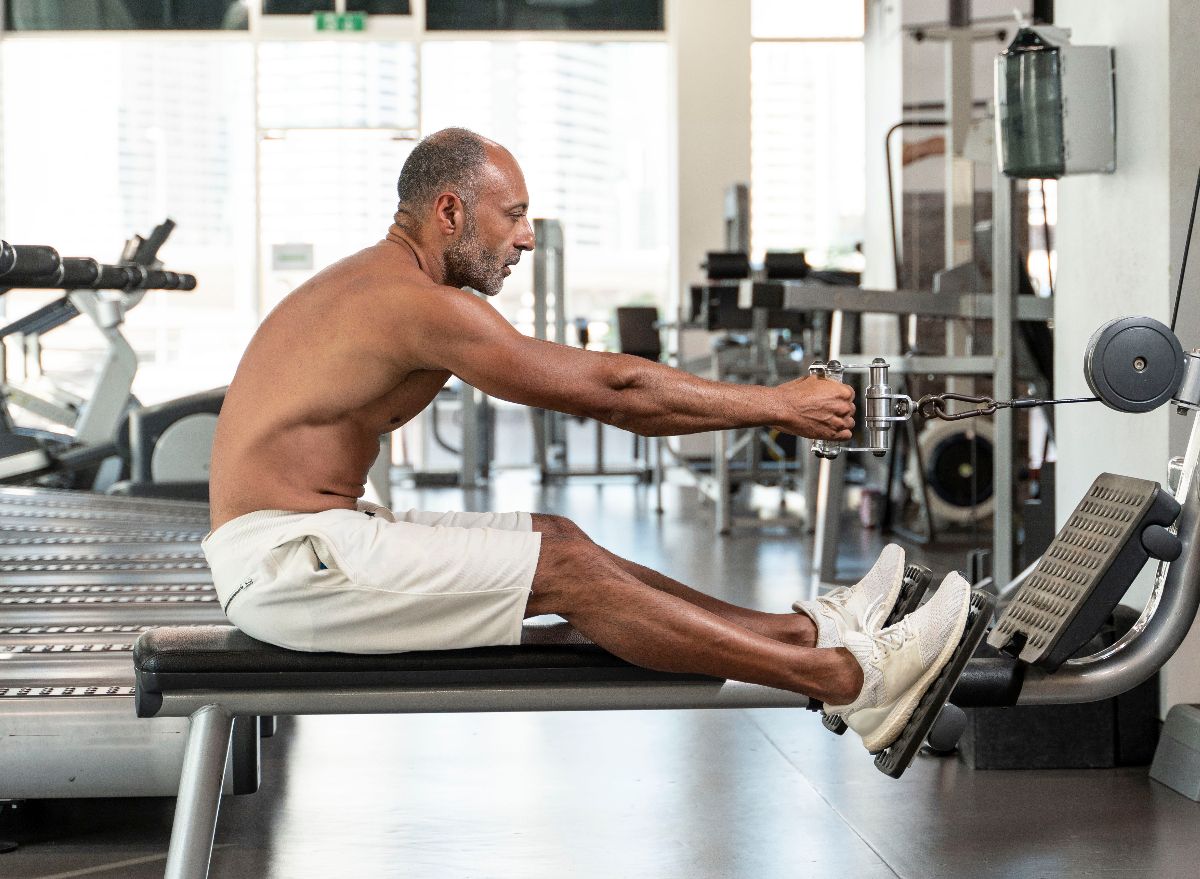 mature man rowing at the gym, concept of the best upper-body compound exercises