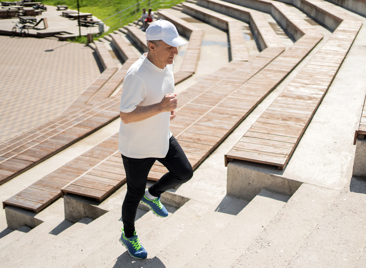 mature man running up stadium stairs, cardio habits that destroy your body after 50 concept