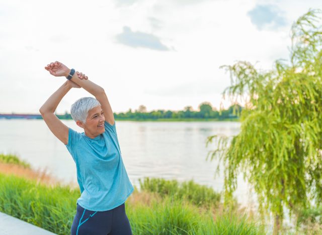 mature runner stretching outdoors