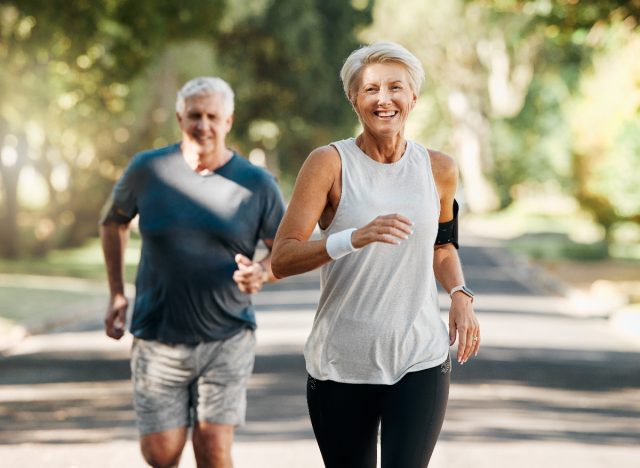 mature woman and husband doing cardio outdoors