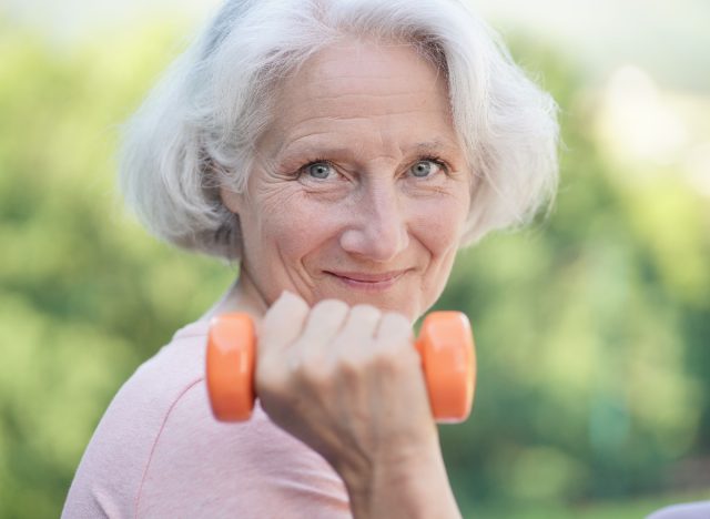 mature woman lifting weights, concept of tips for women to lose belly fat