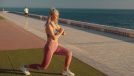mature woman doing lunges outdoors by the water, bodyweight exercises to slow aging concept