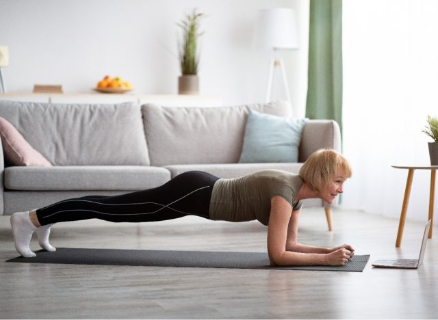 mature woman doing planks at home