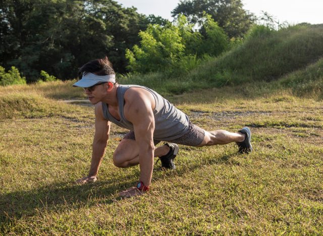 man doing mountain climbers exercise on the grass