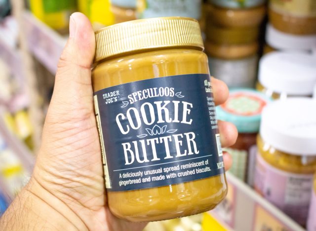 person holding a jar of trader joe's speculoos cookie butter