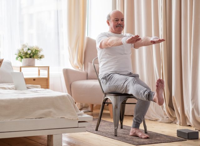 senior man doing seated leg extension, demonstrating exercises for seniors to prevent falls