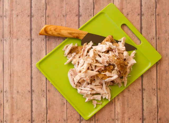 shredded rotisserie chicken on cutting board