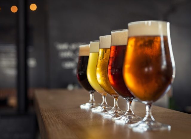 Tap beer in pint glasses arranged in a row.