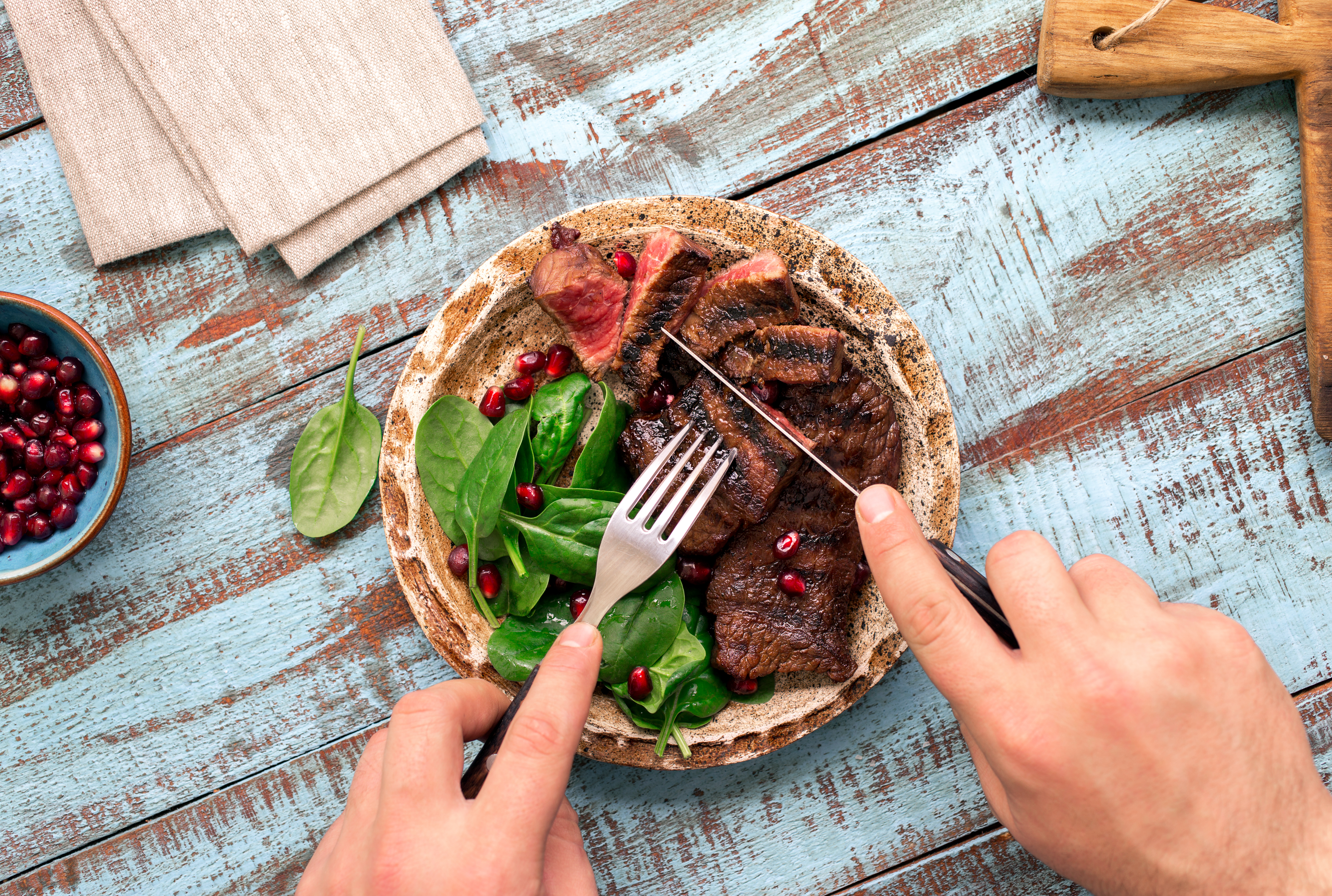 person cutting steak