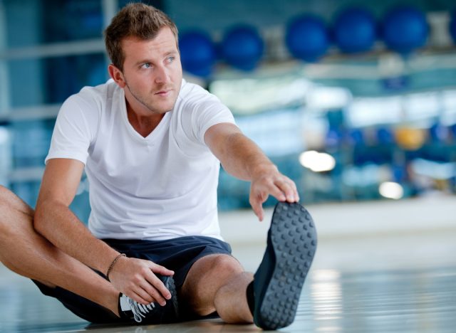 man stretching at the gym