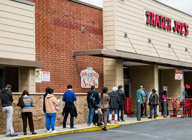 shoppers wait outside Trader Joe's grocery store