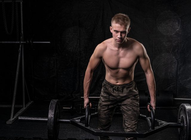 muscular man doing trap bar deadlift