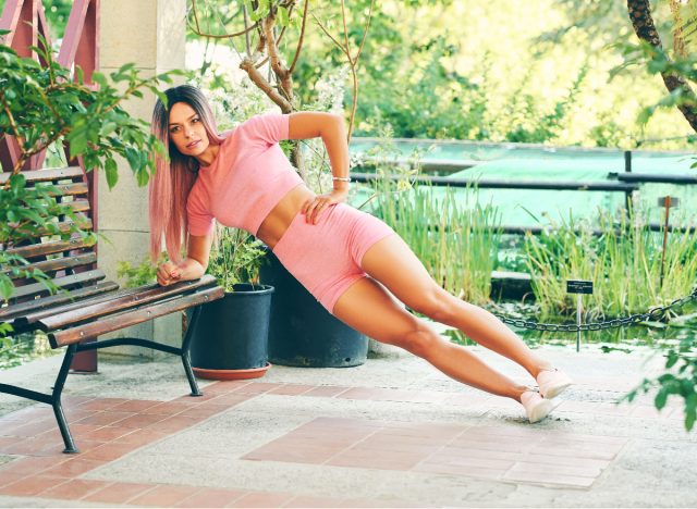 woman doing side plank on bench