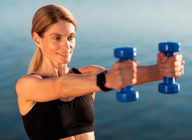 woman holding dumbbells as part of anti-aging workout