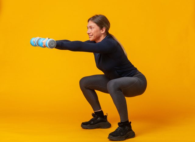 middle-aged woman doing dumbbell squats, demonstrating exercises to change your body shape after 40