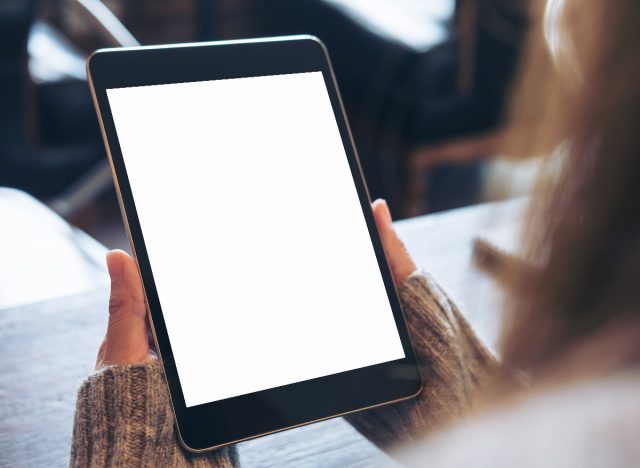 woman holding tablet