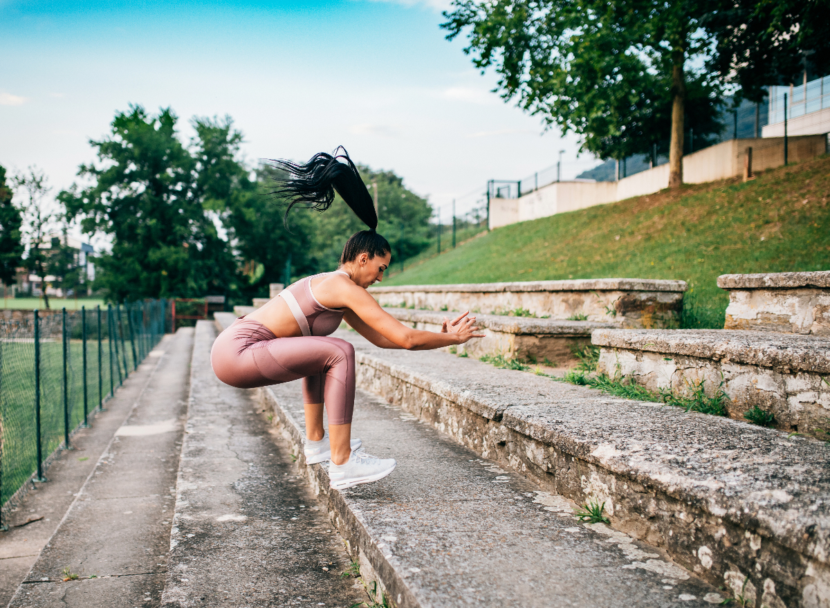 woman doing jump squats as part of bodyweight workout to lose five pounds