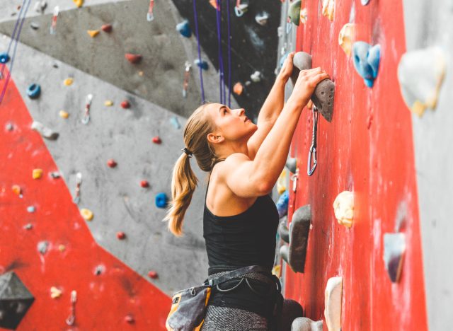 woman doing indoor rock climbing, alternative workouts