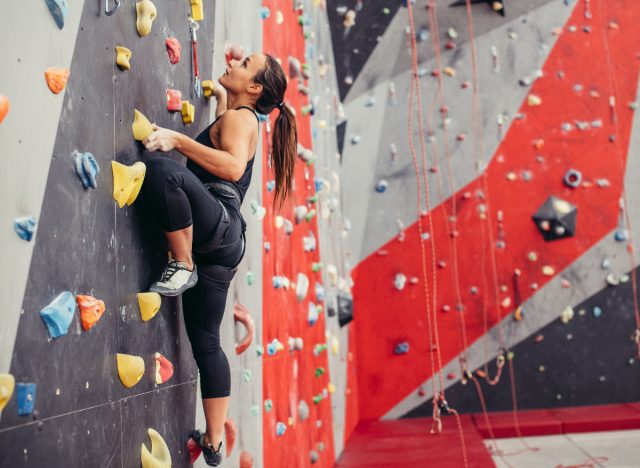 fit woman rock climbing