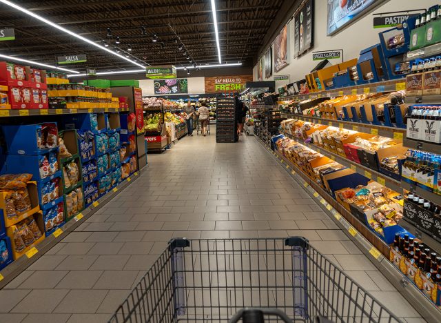 People shopping in the bread aisle of an Aldi store.