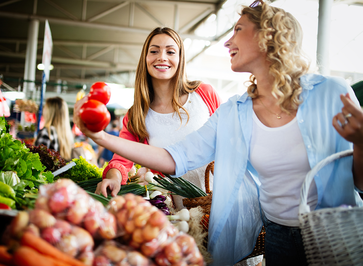 Women shopping vegetables and fruits at the market.