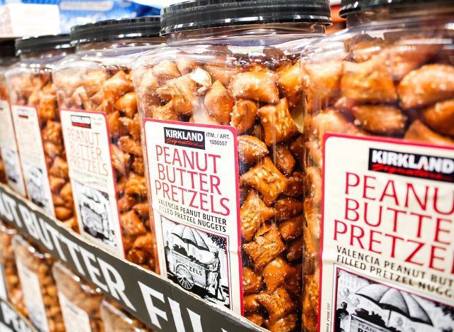 A view of several containers of Kirkland Signature Peanut Butter Pretzels on display at a local Costco.