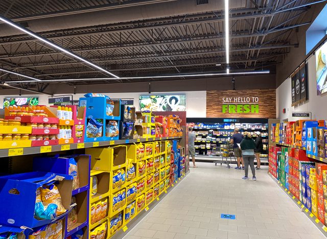 A display of a variety of potato chips and cookies at an Aldi grocery store waiting for customers to purchase.
