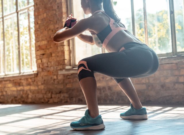 woman doing bodyweight squats, concept of exercises for weight loss