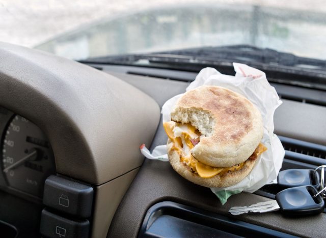 eating breakfast sandwich while driving in car