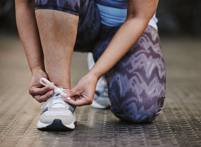 close-up woman tying sneakers