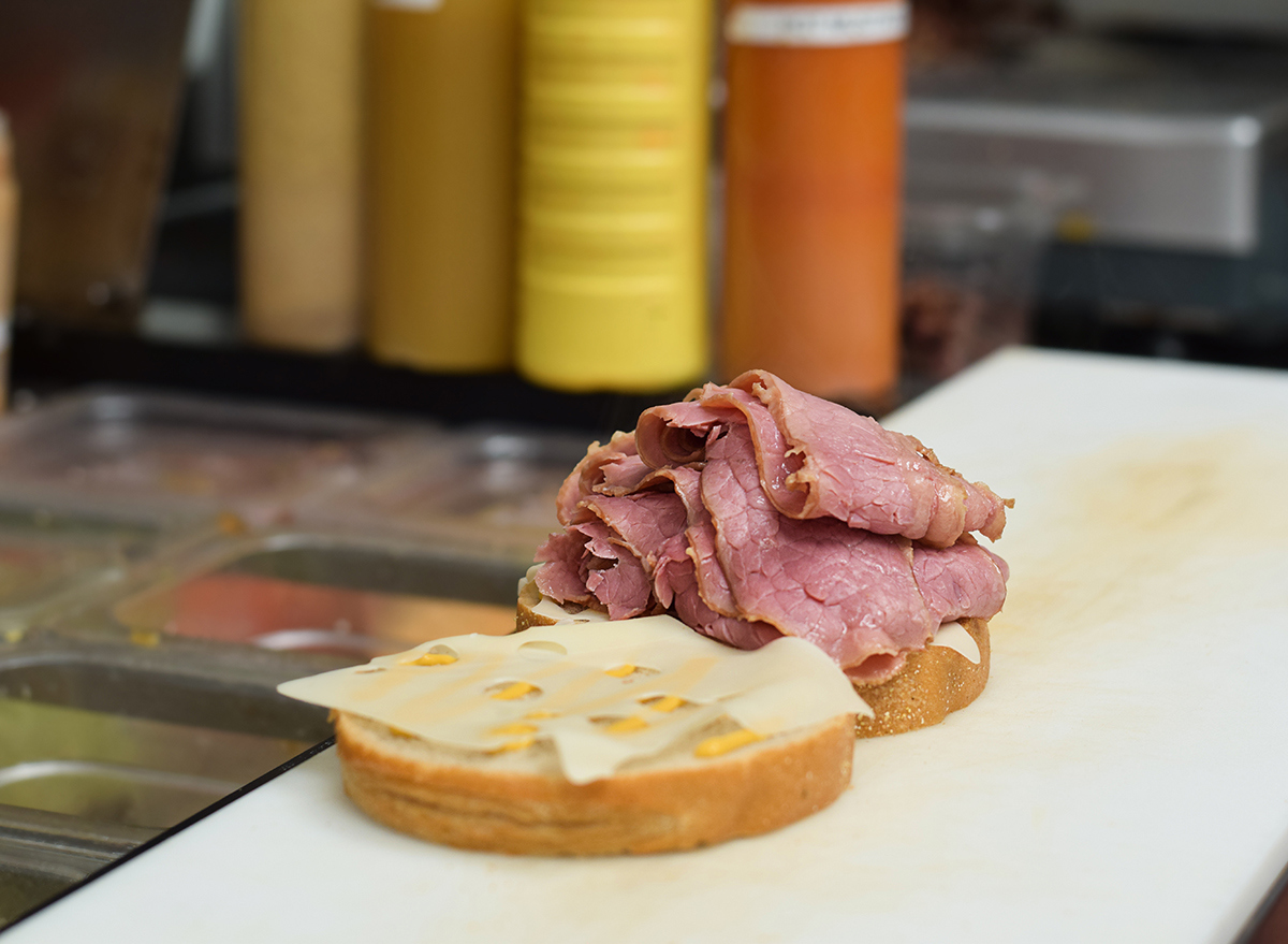 An open deli meat corned beef sandwich