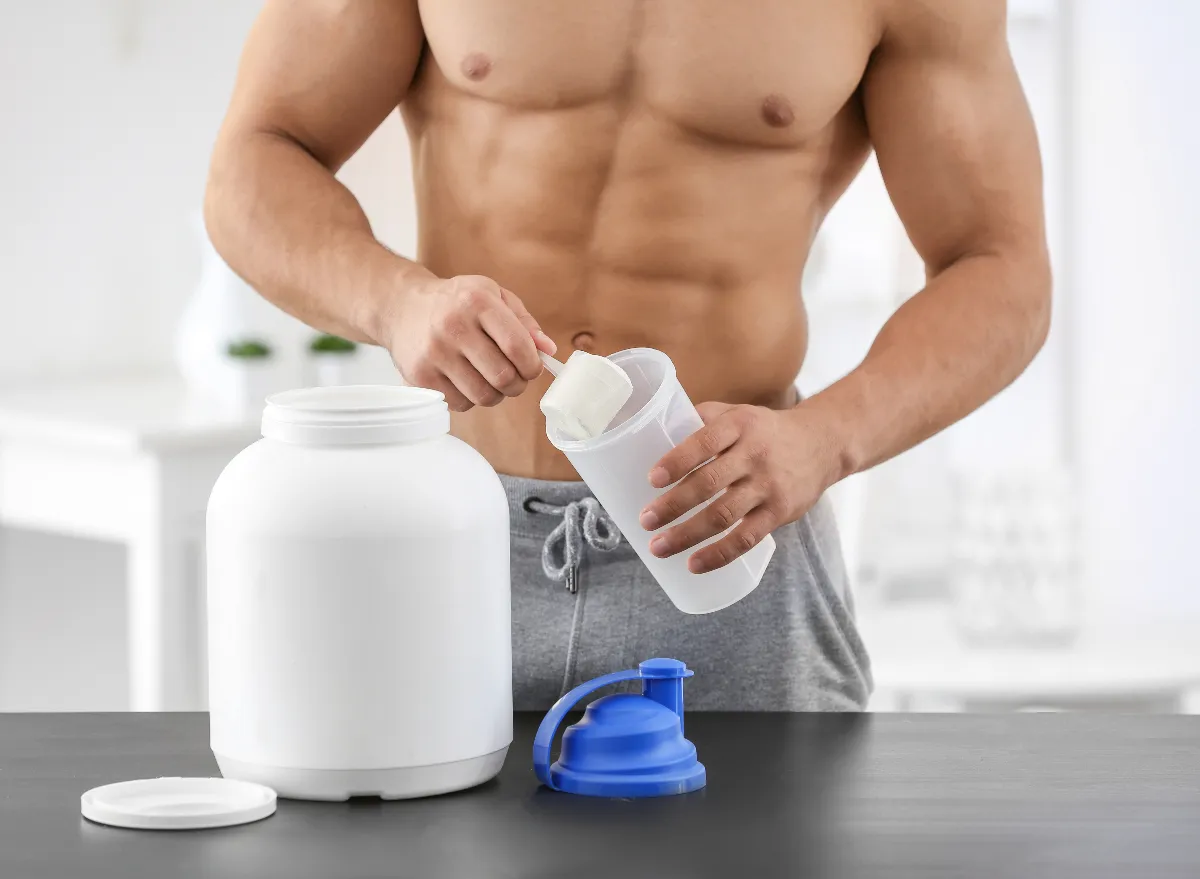 fit man making protein shake, concept of tips for men to lose belly fat and keep it off