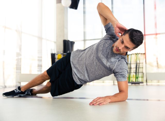 fit man doing side plank, concept of exercises for men to build strength