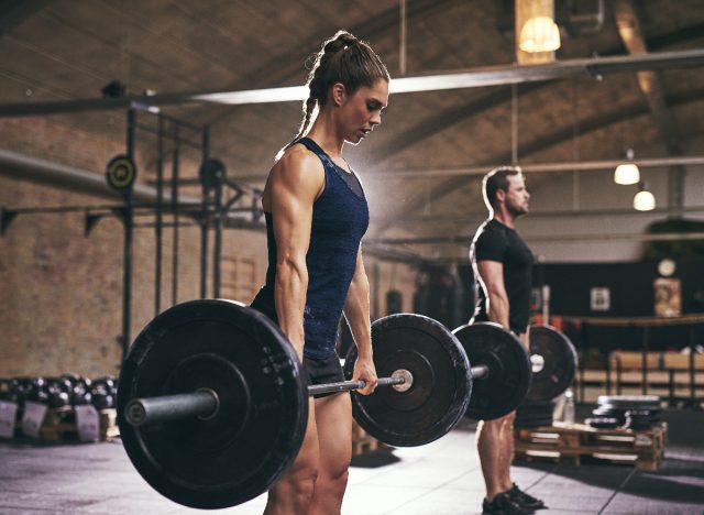 fit woman doing deadlifts, body recomposition exercises