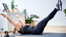 woman doing hollow body hold exercise