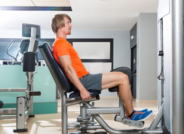 man doing leg abduction machine, concept of machine exercises for men to build powerful legs