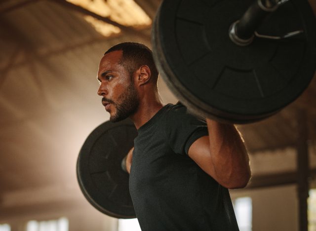 fit man doing barbell lift exercise