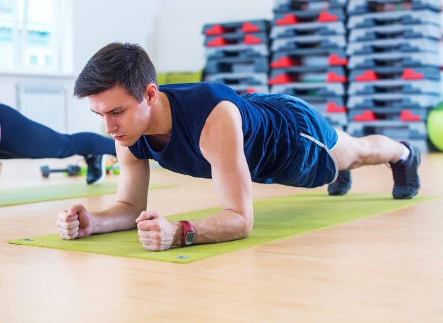 man performing forearm plank, one of the best exercises to build up your core