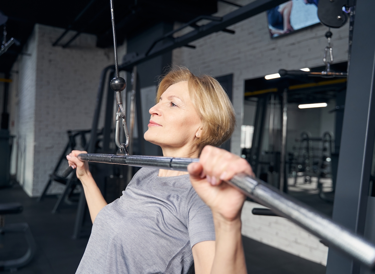 mature woman doing lat pulldown strength exercises to prevent injury after 50
