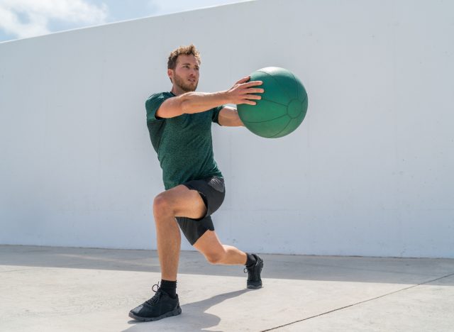 man doing medicine ball lunge