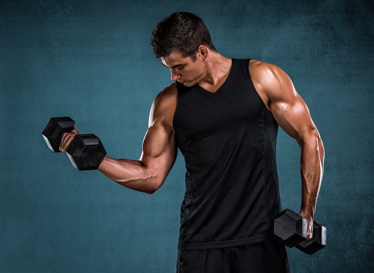 muscular man lifting weights, concept of muscle-building workouts for men