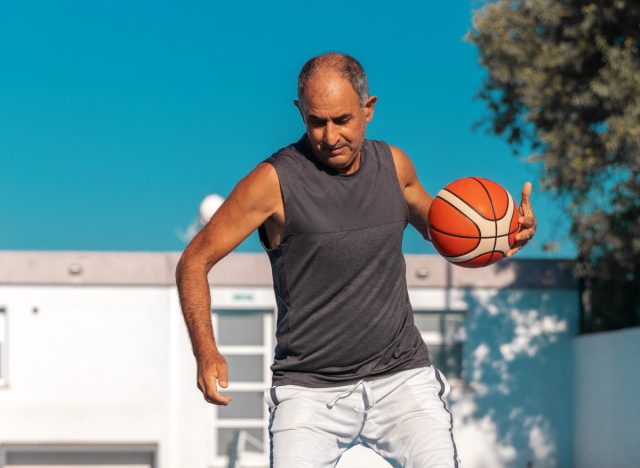 mature man playing basketball