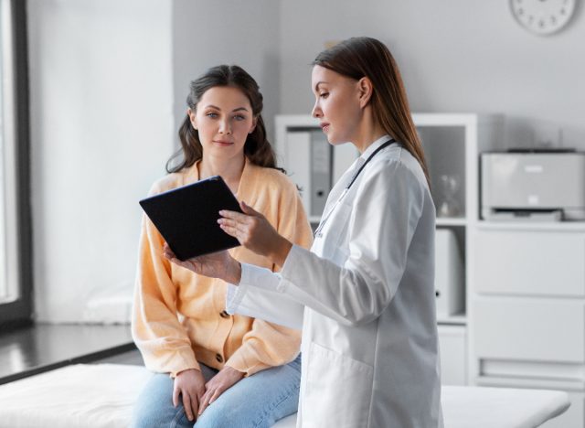 doctor speaking with female patient in exam room setting