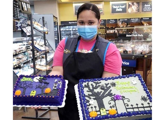 walmart employee holding halloween cakes