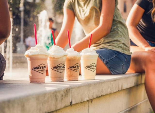 a row of milk shakes on a curb.