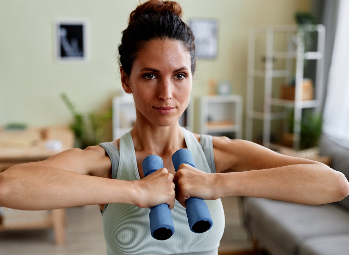 close-up of woman doing dumbbell strength exercises for a lean upper body