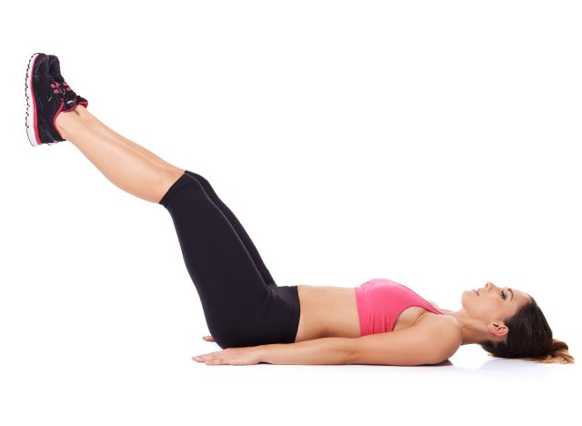 woman doing leg lifts as part of six-pack workout