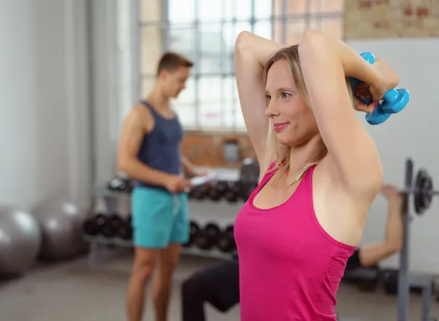 woman doing overhead tricep extensions