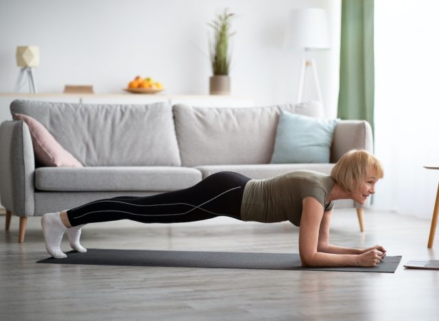 woman doing planks exercise in living room