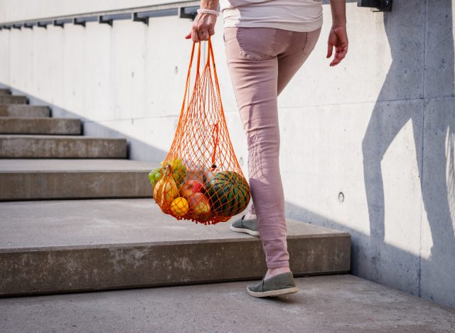 woman carrying grocery bag
